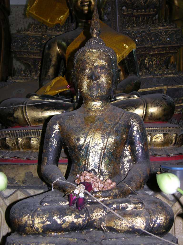 Bangkok 02 07 Lucky Buddha The tuk-tuk driver has to make some extra money somehow. Our next stop was one of those. We visited the so-called Lucky Buddha, supposedly only open one day a year, and this was our lucky day. This is really just an average temple. The caretaker was very friendly and had supposedly had visited Canada a few times. If we were looking for some of the famous Thai jewelry, he recommended a certain shop. We went there, and yes, we bought something. We were quite satisfied. He then took us to a suit shop, but we simply said no, and we were off again to finish our tour at Wat Saket. We paid the tuk-tuk driver his 100 Baht and gave him a tip of another 100 Baht. The tour was a lot of fun.